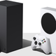 The Xbox Series X (left) and Series S (white) are stood up side-by-side, with the Series X truly towering over the Series S.